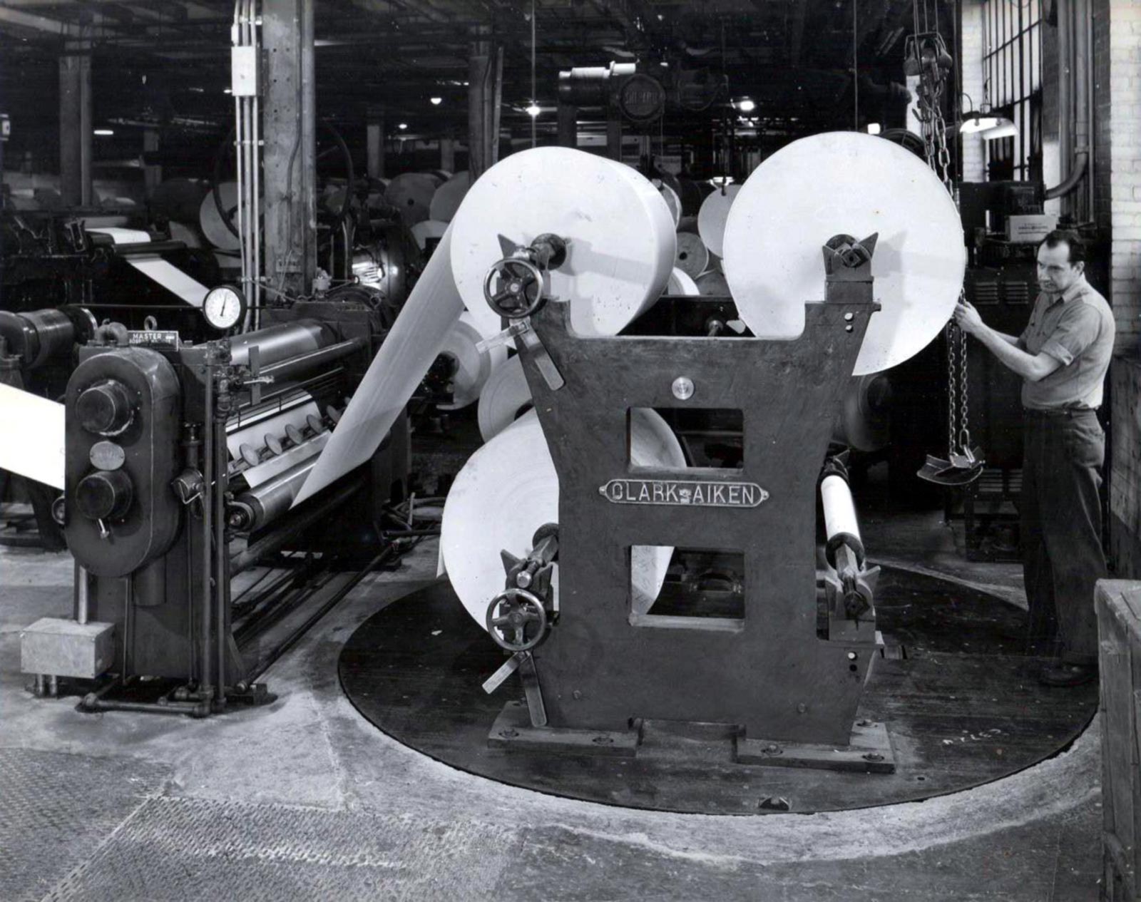 Hammermill Worker with Large Paper Rolls